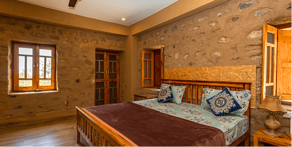 Rustic bedroom with wooden interiors and large windows